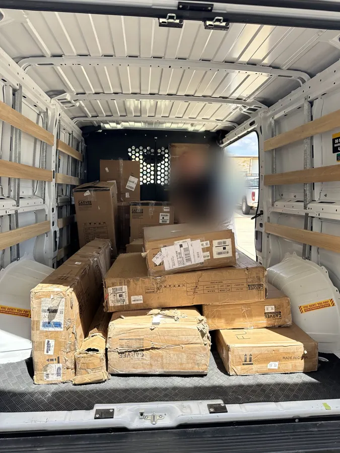 Buyer loading a cargo van with winning lots
