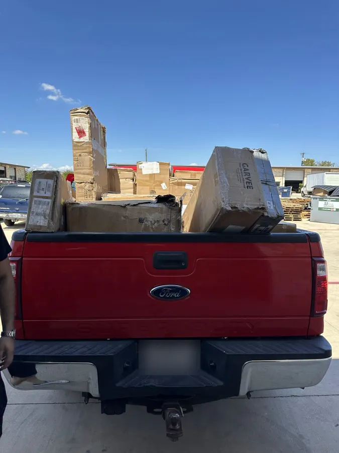 Red pickup truck loaded with auction wins